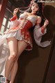 A woman in a red and white dress leaning against a wall.