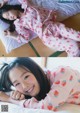 A young girl laying on a bed in pajamas.