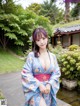 A woman in a blue kimono posing for the camera.