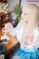 A woman sitting at a table eating a piece of cake.