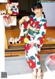 A woman in a kimono is posing for a picture.